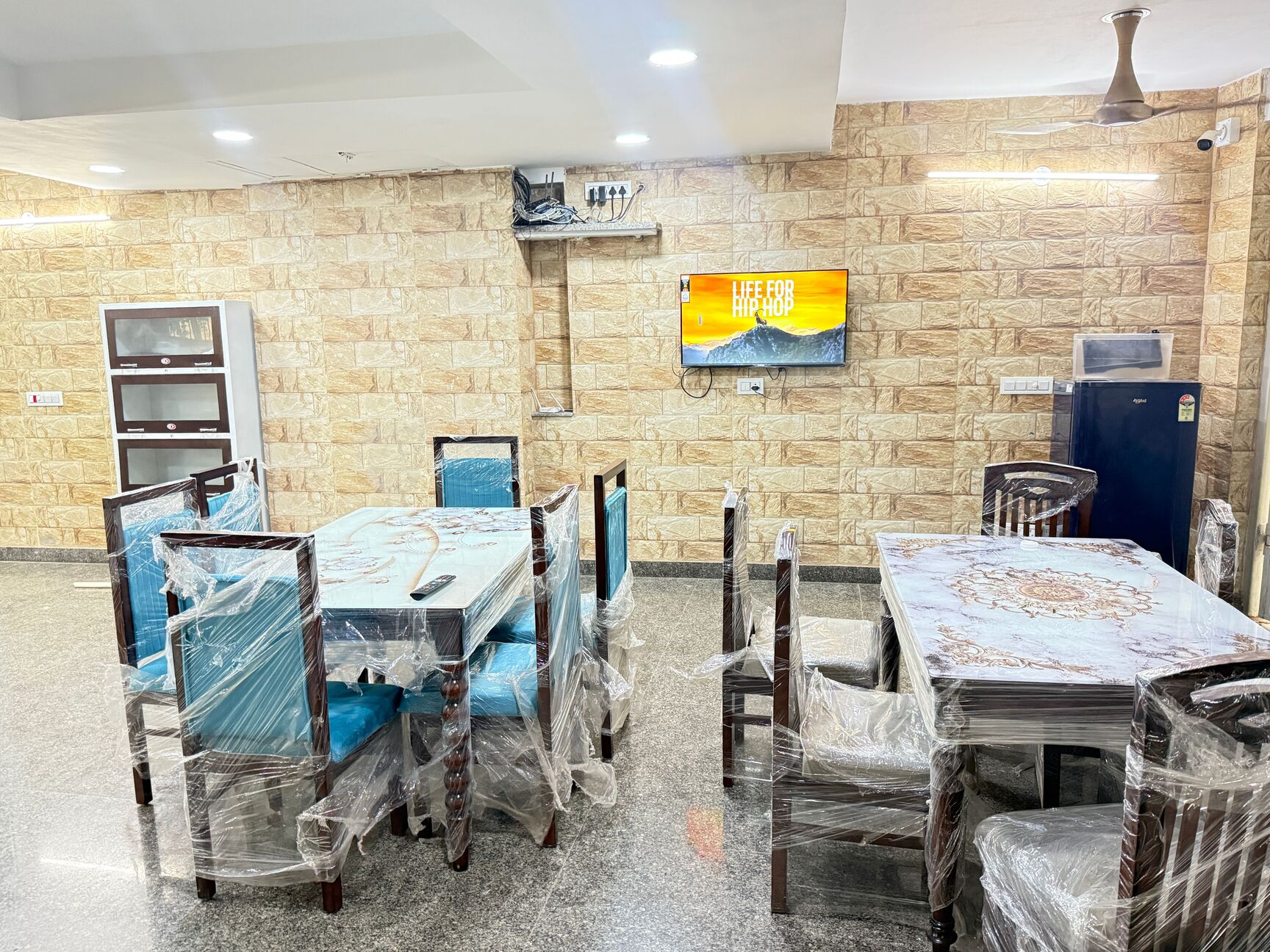 Spacious dining hall with TV at Happy Living